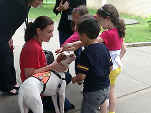 Barbra Tolan from the Mayor's Alliance for NYC's Animals introduces pre-K students at P.S. 209 in Whitestone, Queens, to one-and-a-half-year-old Pit Bull, Charlie. (Photo by Mayor's Alliance for NYC's Animals)