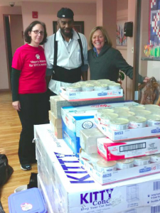 Urban Resource Institute shelter employee, Junior Pilgrim, accepts URIPALS pet supplies and equipment from Jenny Coffey and Debbie Fierro from the Mayor's Alliance for NYC's Animals on November 10. (Photo by Ann Michitsch)