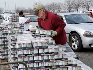 Certified TNR Caretakers line up to have their cars loaded up with cat food by volunteers, John Iannuzzi and Gurjinder Cheema, and staff member, Kathleen O'Malley, at the NYC Feral Cat Initiative's giveaway on December 12, 2015. (Photo by Maureen Smith)