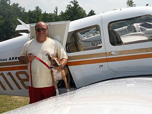 Pilot Art Dreyer flew Lizzie, a dog rescued by the Miniature Bull Terrier Club of America, from Florida to the June 19 fly-in in South Carolina, where she caught her second flight to Ohio with another pilot the following day. (Photo by Debi Boies)